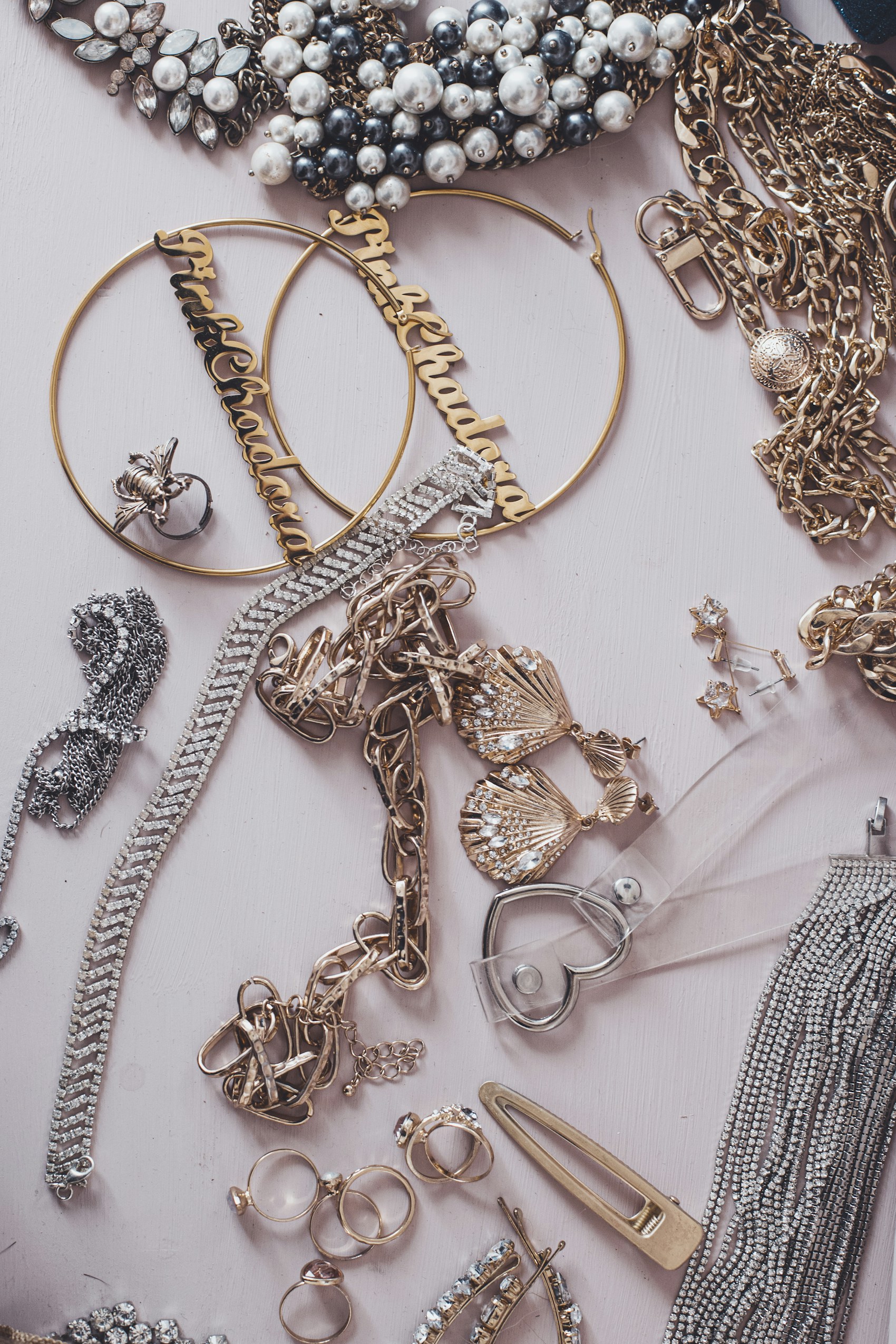 Gold-tone necklaces and pearl-look accents on a display surface.
